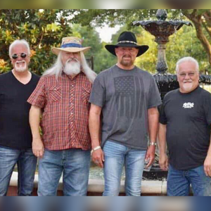 4 Members of Confederate Railroad band pose outdoors for a photo