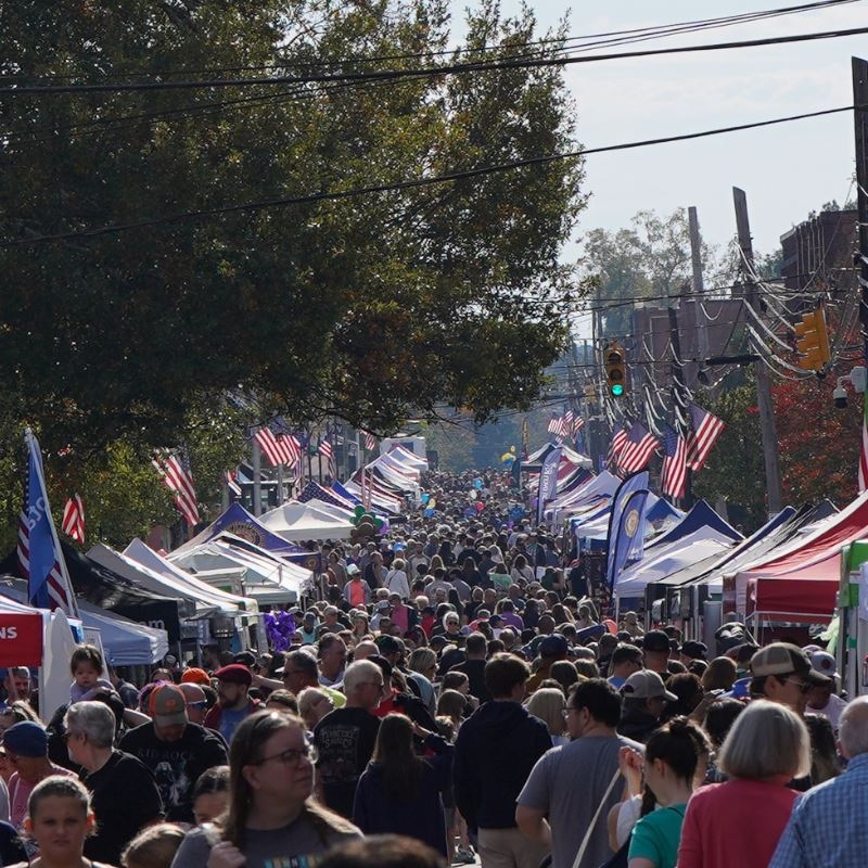 Large crowd of people roam main street at clayton harvest festival