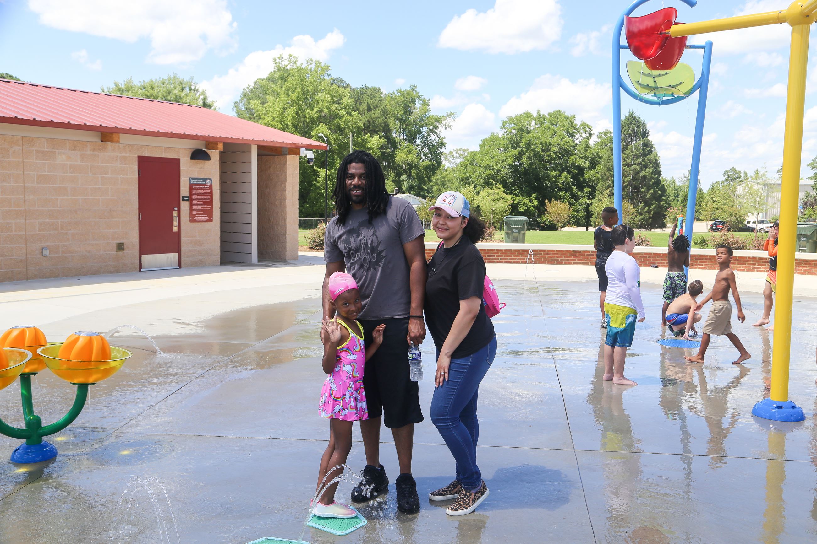 Dwayne-L and Jessica-R Osborne with their daughter at the splash pad