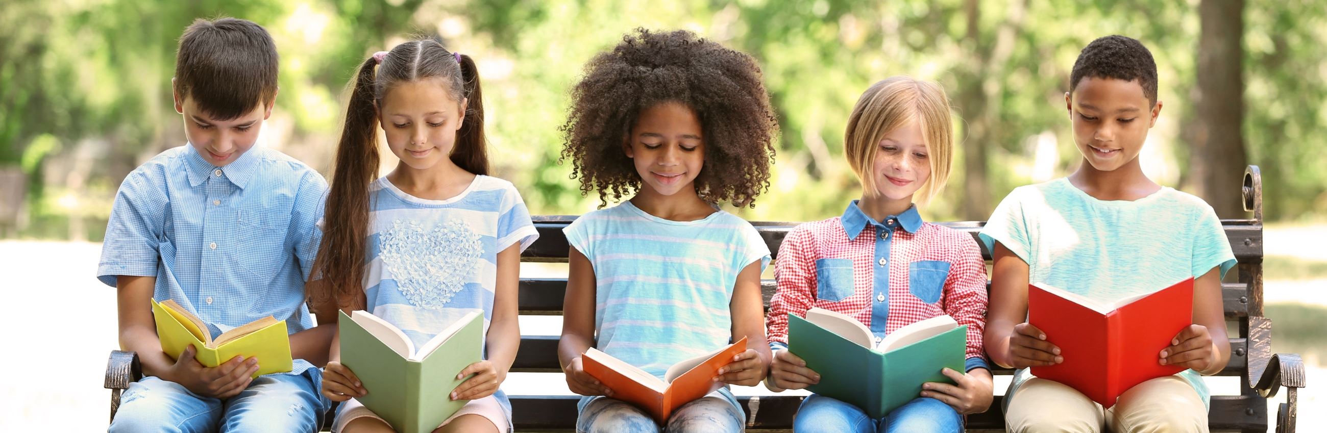 Five Children Read Books on Park Bench